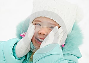 Portrait of cute laughing little girl in winter day