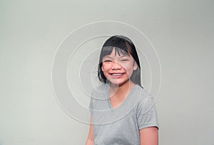 Portrait of a cute little Asian girl standing relaxed smiling happy face, Asian baby fashion that looks beautiful and cute, bright