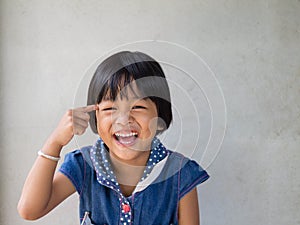 Portrait of cute little asian girl with toothy smile