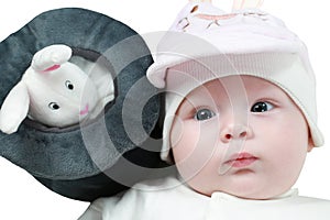 Portrait of cute little baby girl with blue eyes and toy rabbit