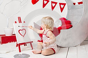 Portrait of a cute little baby girl in a decorated holiday studio of the Valentine`s day