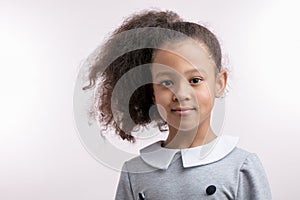 Portrait of cute little beautiful mulato girl with ponytail photo
