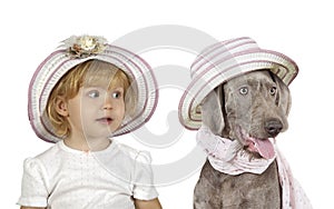 Portrait of a cute little blonde girl with a Wirehaired Slovakian pointer dog in the studio