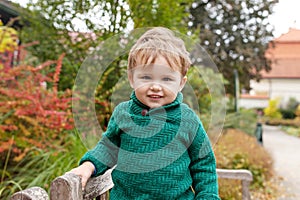 Portrait of cute  little  boy. Happy lovley smiling child in the park. Look at camera photo