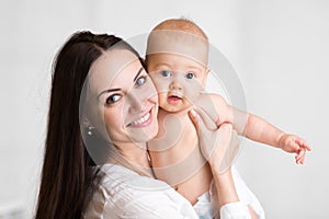 Portrait of cute little boy with mother, baby with