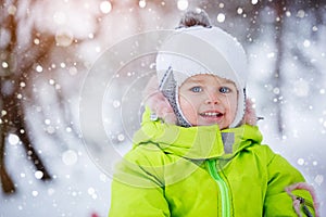 Portrait cute little boy under the snow, wintertime, happiness concept.