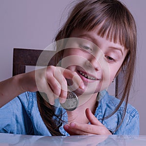 Portrait of cute little cute child with money as symbol of desire to be rich and successful