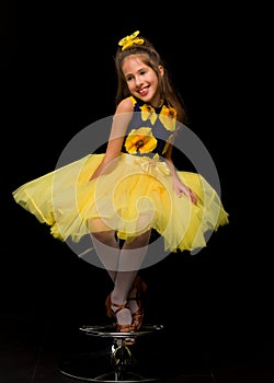 Portrait of a cute little girl on a black background. Happy chil