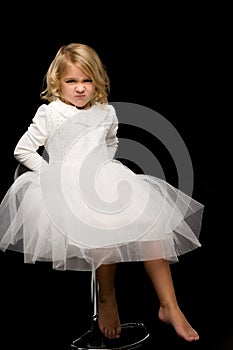 Portrait of a cute little girl on a black background. Happy chil