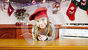 Portrait of cute little girl chef in the christmas kitchen