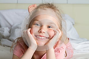 Portrait of cute little girl dreaming in bed