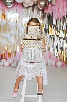 Portrait of a cute little girl with gifts