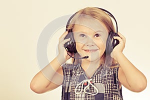 Portrait of cute little girl with headphones on her head