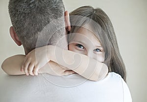 Portrait of cute little girl held in father arms. Happy loving family. Father and his daughter child girl playing hugging