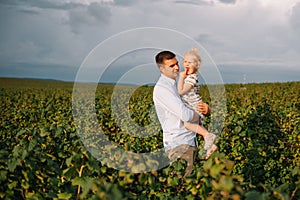 Portrait of cute little girl held in father& x27;s arms. Happy loving family. Father and his daughter child girl playing
