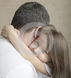 Portrait of cute little girl held in father`s arms. Happy loving family. Father and his daughter child girl playing hugging