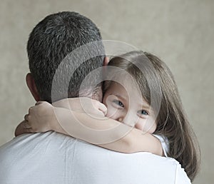 Portrait of cute little girl held in father`s arms. Happy loving family. Father and his daughter child girl playing hugging