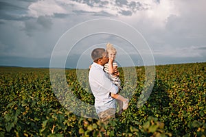 Portrait of cute little girl held in father`s arms. Happy loving family. Father and his daughter child girl playing hugging. Cute