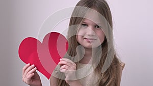 Portrait of cute little girl holding big red heart on white background. Valentines Day, love, mothers Day, romantic