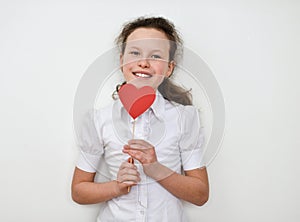 Portrait of cute little girl holding red heart.Isolated on white background.
