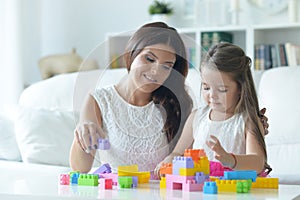 Portrait of cute little girl playing with mother