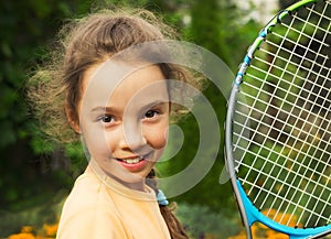 Portrait of cute little girl playing tennis in summer