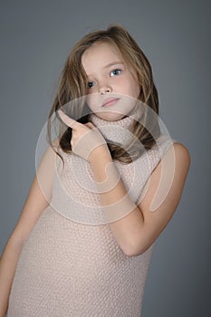 Portrait of a cute little girl pushes her hair from her face. photo