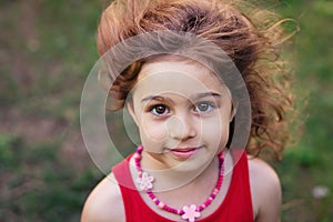 Portrait of cute little girl smiling outside