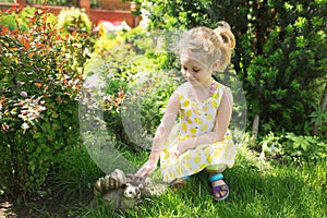 Portrait of a cute little girl in sunny day at green natu