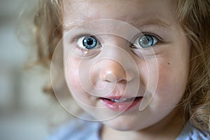 Portrait of a cute little girl with a tear in her eyes