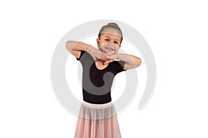 Portrait of cute little girl wearing dance suit, smiling and propping up her head with hands , isolated on white