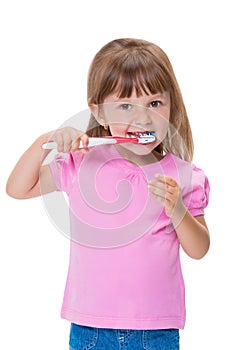 Portrait of cute little girl 3 year old in pink t-shirt brushing her teeth isolated on white background