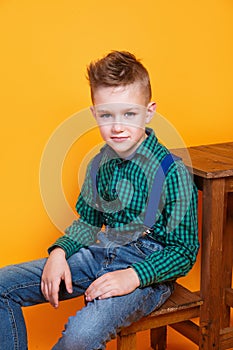 Portrait of cute little kid boy in stylish jeans clothes looking at camera