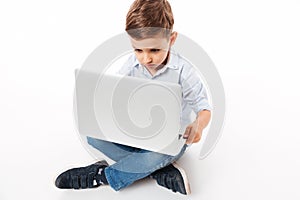 Portrait of a cute little kid using laptop computer