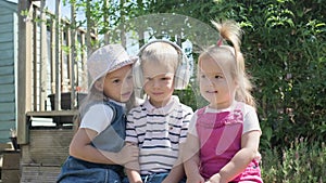 Portrait of Cute Little Three Children With Headphones Listening to Music. Cheerful Carefree Childhood. Preschool