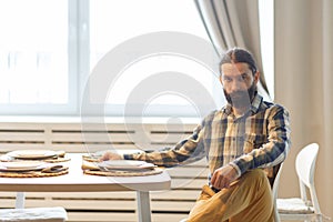 Portrait of a cute long-haired man with a beard