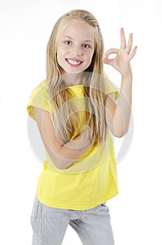 Portrait of cute lovely beautiful adorable sweet with beaming smile in yellow tshirt girl making ok symbol.