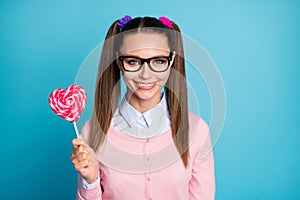 Portrait of cute lovely girl university student hold heart shape lollipop stick enjoy lesson break wear good look