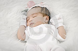 Portrait of cute newborn baby sleeping on white blanket