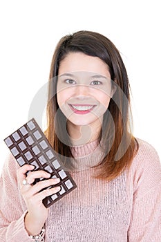 Portrait of a cute pretty girl holding chocolate bar under white background