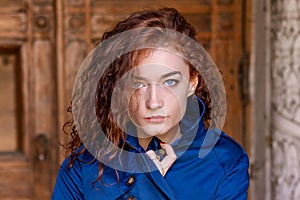 Portrait of cute red-haired girl , wavy hair and beautiful eyes