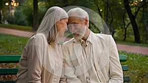 Portrait cute romantic happy senior family smiling Caucasian elderly couple man woman cuddling talk discuss looking at
