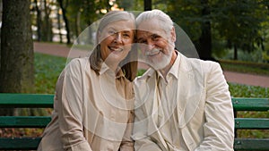 Portrait cute romantic happy senior family smiling Caucasian elderly couple man woman cuddling talk discuss looking at