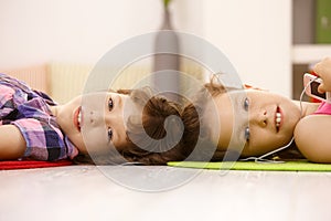 Portrait of cute schoolgirls listening to music photo