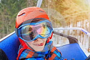 Portrait of Cute skier boy in a winter ski resort.