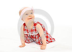 Portrait cute smiling baby in dress with headband crawls