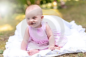 Portrait of cute smiling baby girl, outdoors, light effect