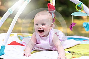 Portrait of cute smiling baby girl, outdoors, light effect