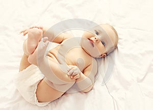 Portrait of cute smiling baby lying on the bed