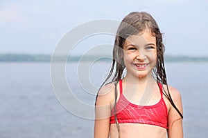 Portrait of cute smiling girl in a red